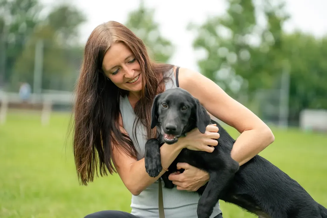Rachel Martin with a black Lab puppy