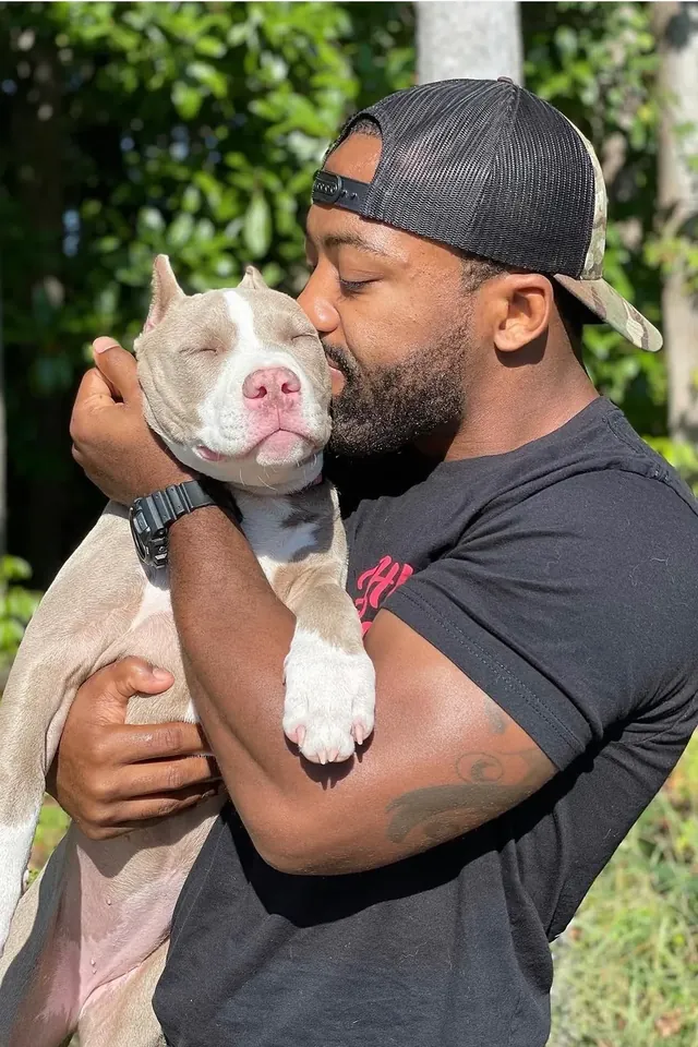 K9aholics trainer hugging a pit bull