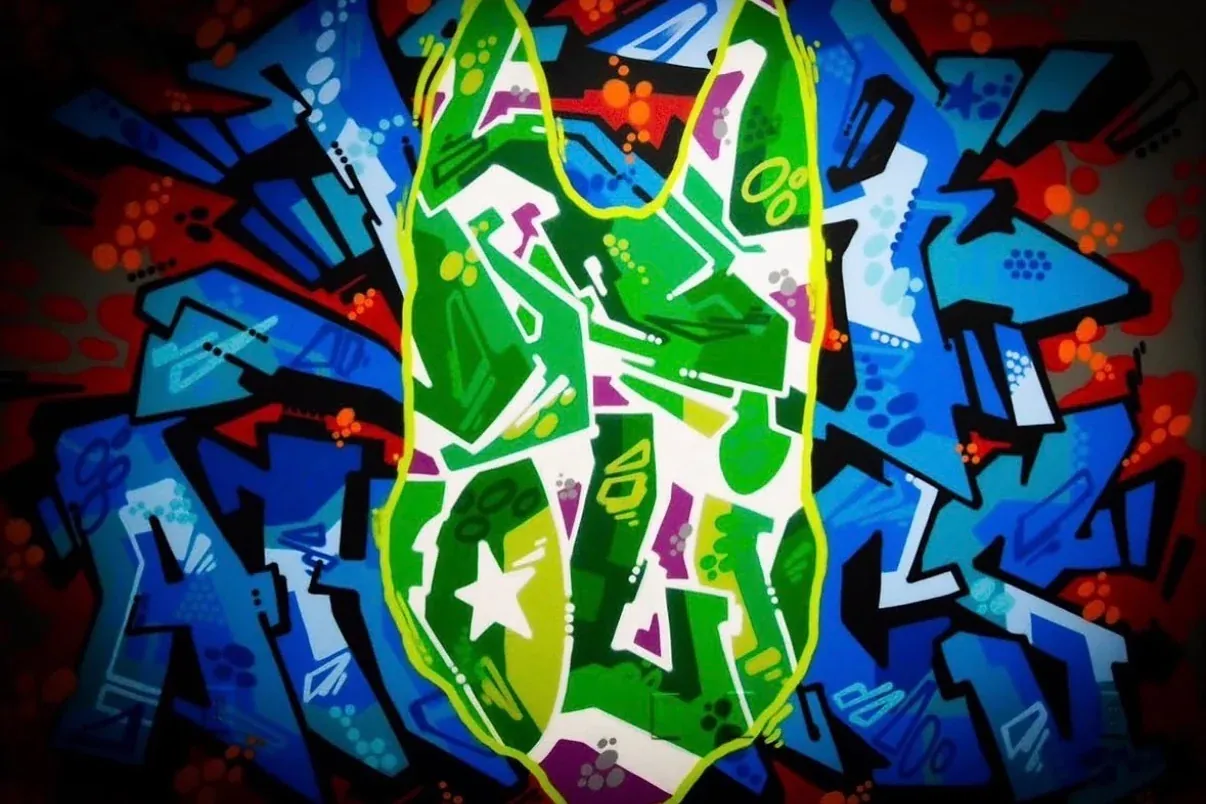 The K9aholics Malinois-head logo painted as a graffiti mural